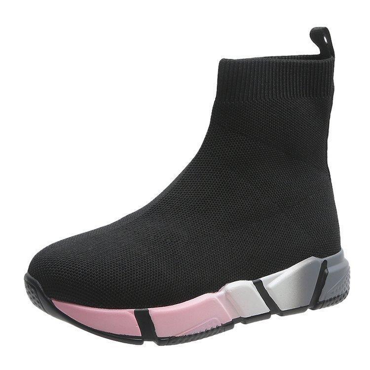 Woman wearing black and pink platform ankle boots