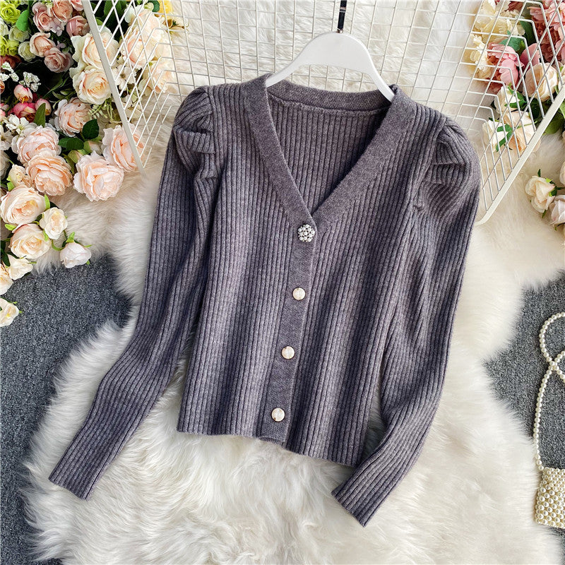 Woman wearing V-neck single-breasted cardigan sweater