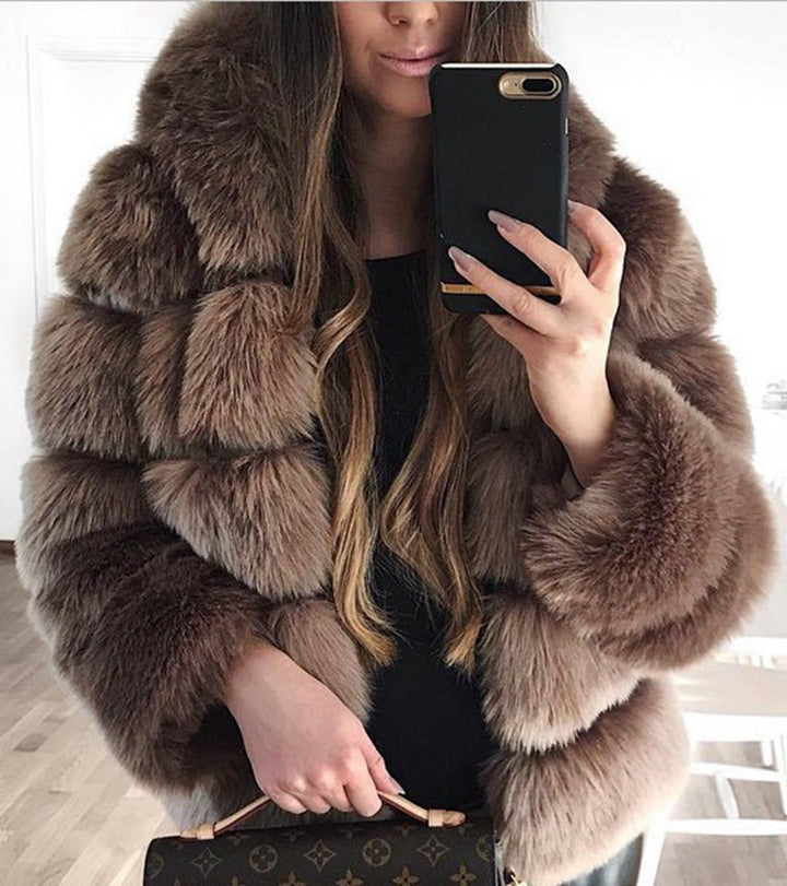 Woman wearing a faux fur winter coat with fur collar