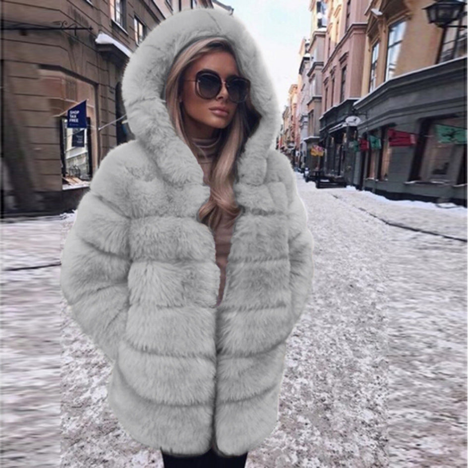 Woman wearing a faux fur winter coat with fur collar