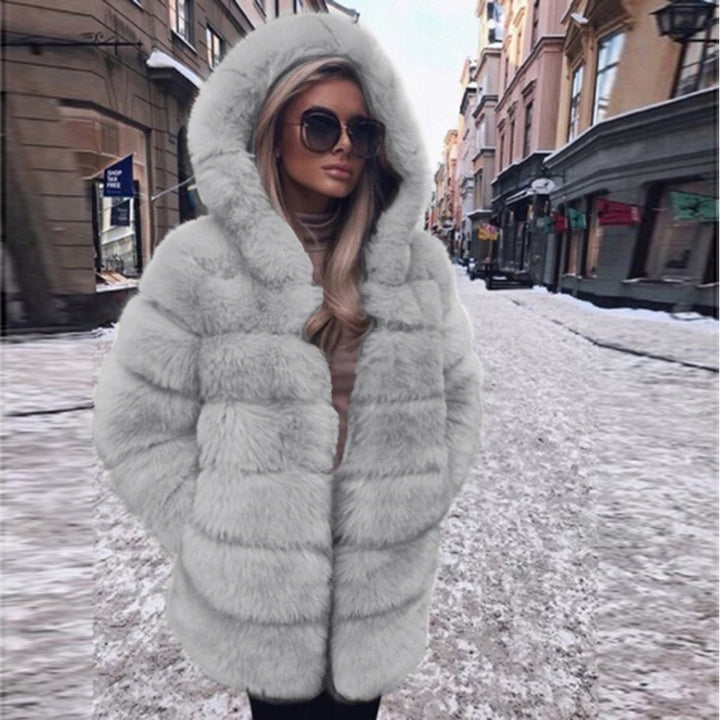 Woman wearing a faux fur winter coat with fur collar