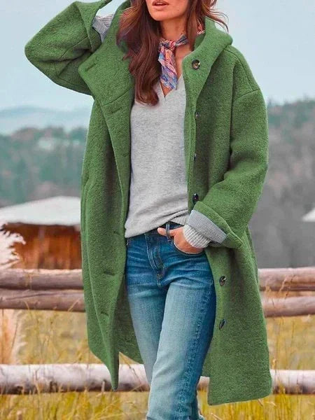 Woman wearing hooded long coat with button front