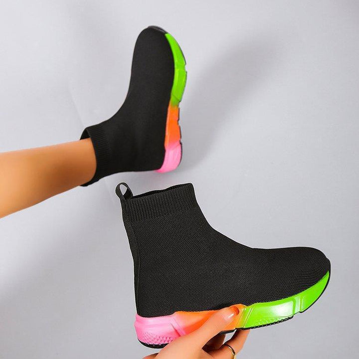 Woman wearing black and pink platform ankle boots