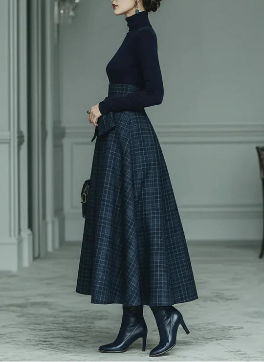 Woman wearing dark blue high-neck top and plaid skirt set