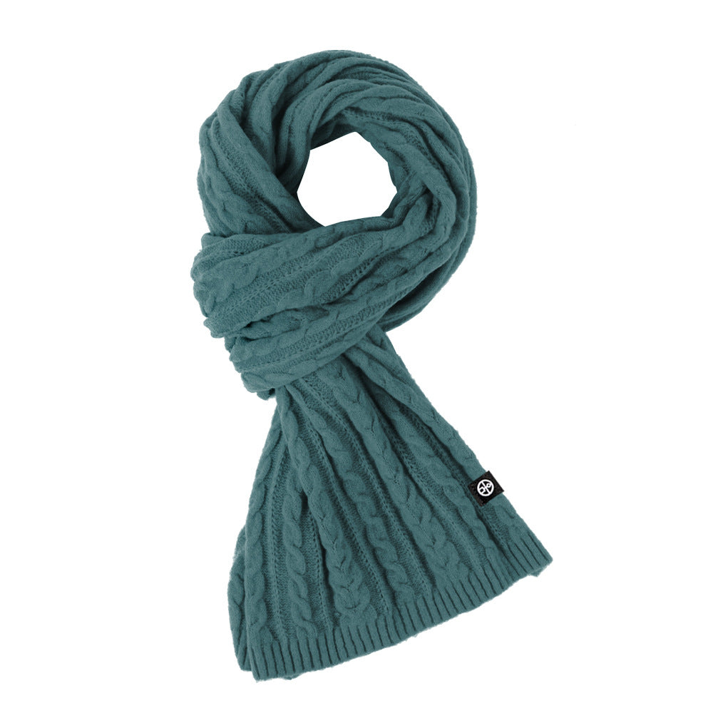 Woman wearing solid color long winter scarf outdoors