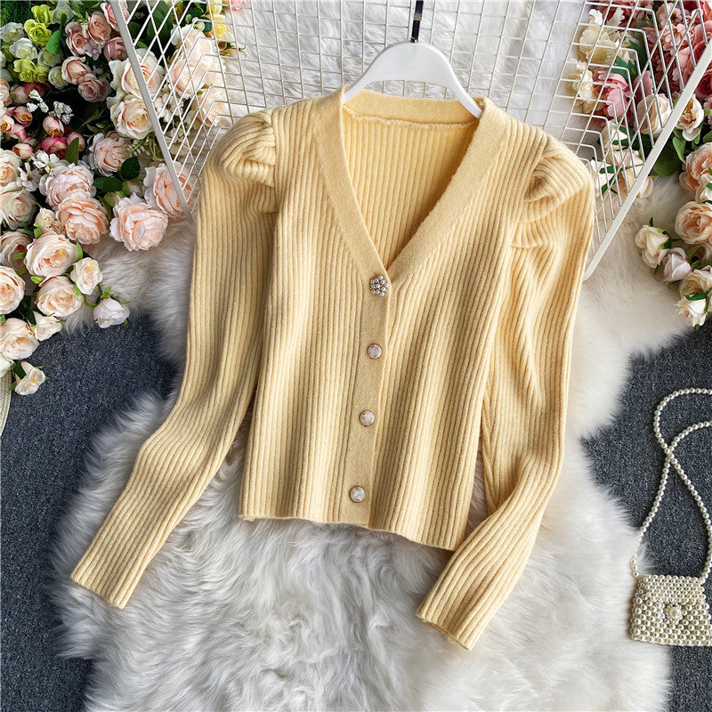 Woman wearing V-neck single-breasted cardigan sweater