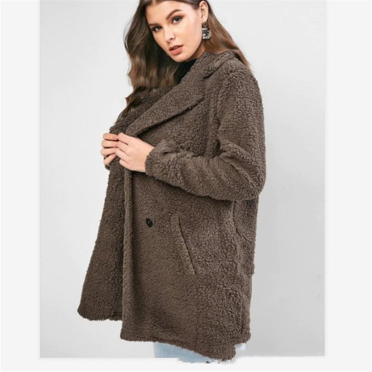 Woman wearing gray mid length loose coat with pockets