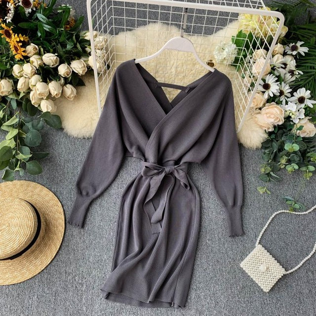Woman wearing knitted sweater dress with lace-up detail