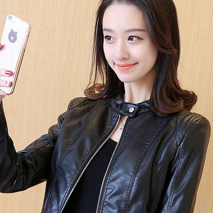 Woman wearing black cropped faux leather jacket with stand collar
