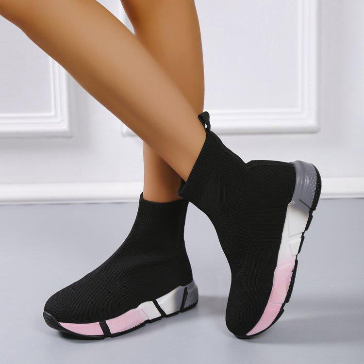 Woman wearing black and pink platform ankle boots