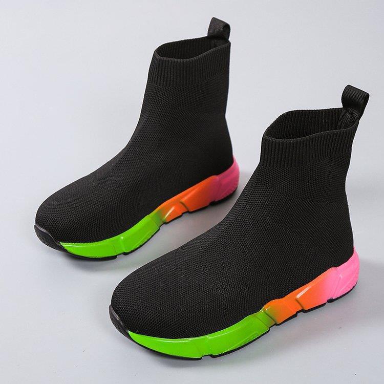Woman wearing black and pink platform ankle boots