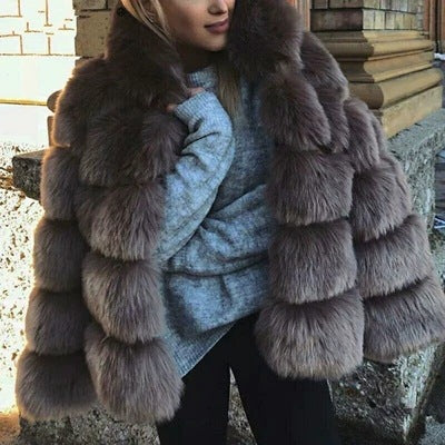 Woman wearing a faux fur winter coat with fur collar