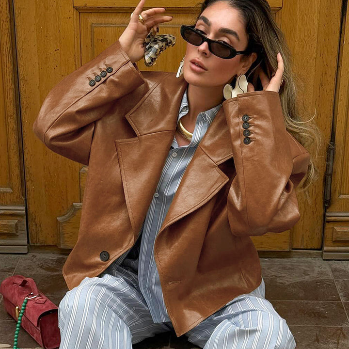 Woman wearing brown suit collar faux leather jacket
