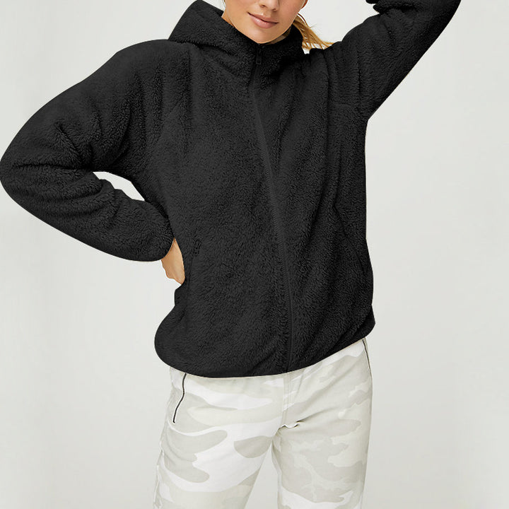 Woman wearing black zip-up hooded blazer front view