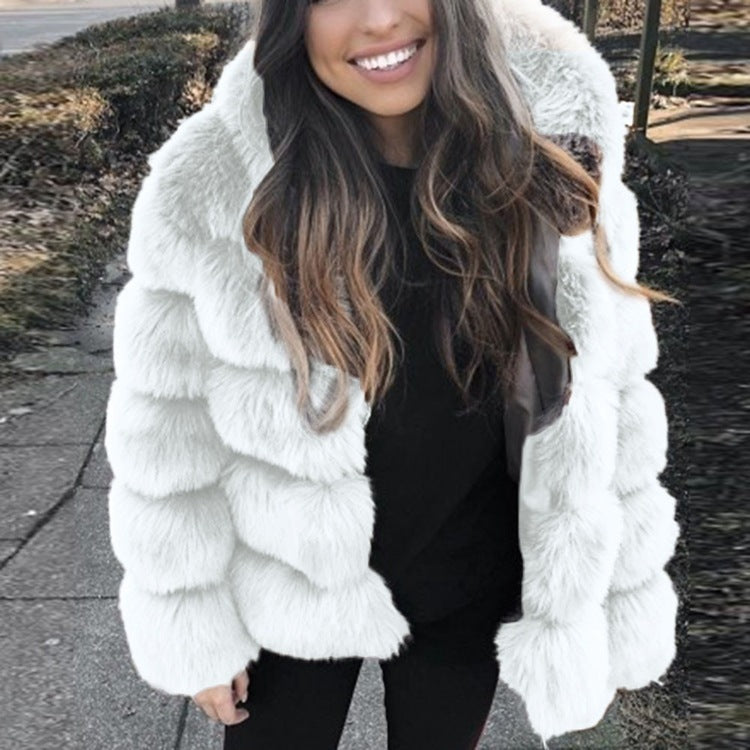 Woman wearing a faux fur winter coat with fur collar