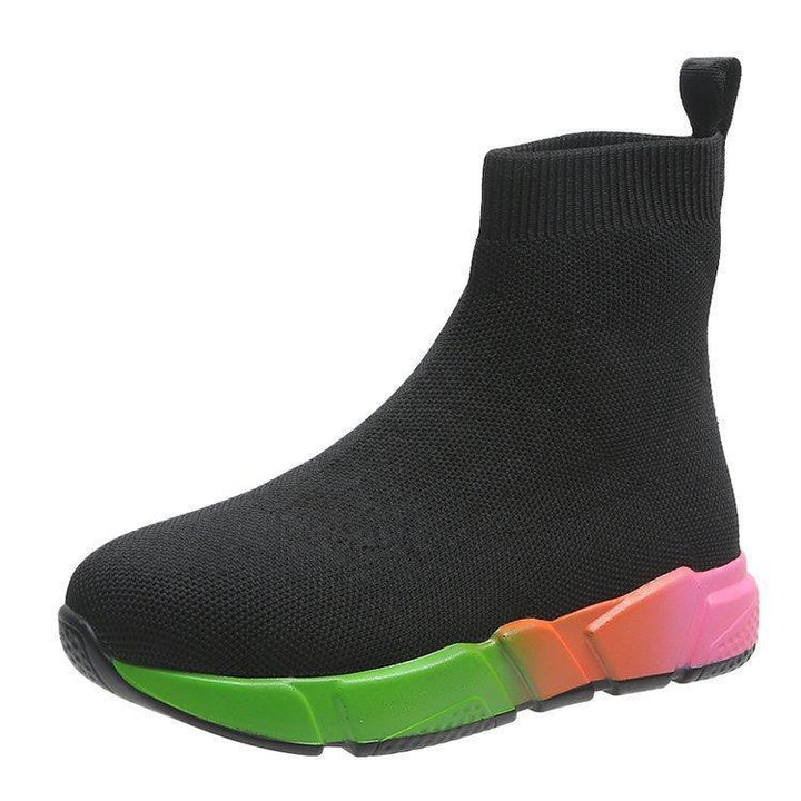Woman wearing black and pink platform ankle boots