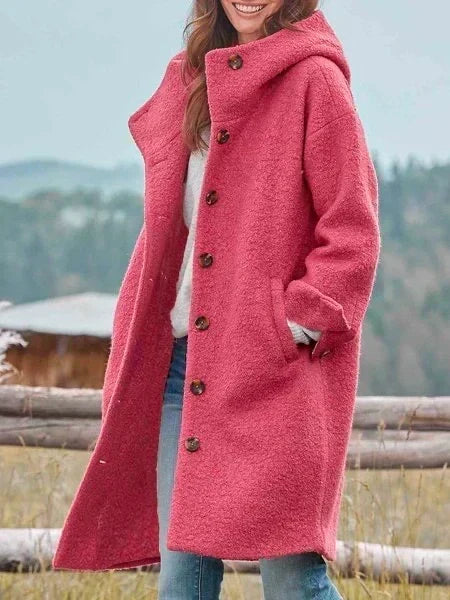 Woman wearing hooded long coat with button front