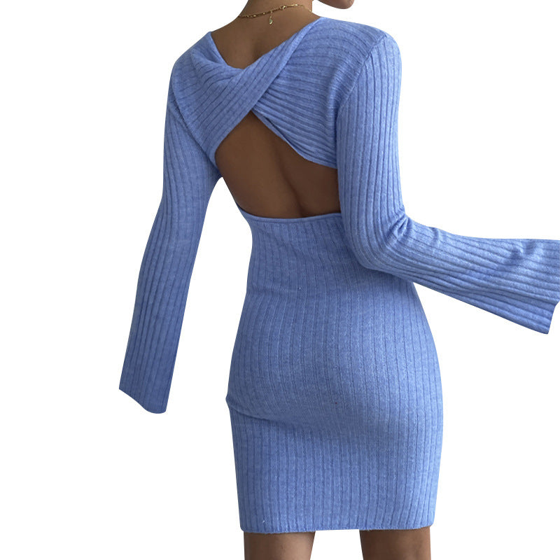 Woman wearing backless sweater dress with bell sleeves