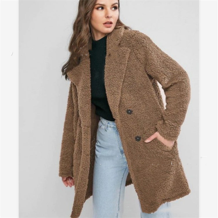 Woman wearing gray mid length loose coat with pockets