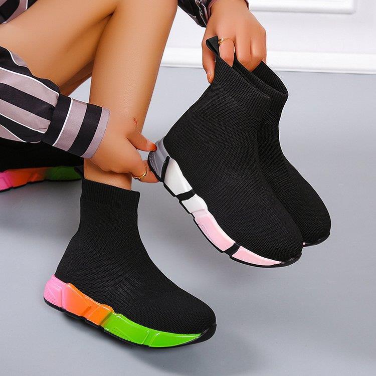 Woman wearing black and pink platform ankle boots