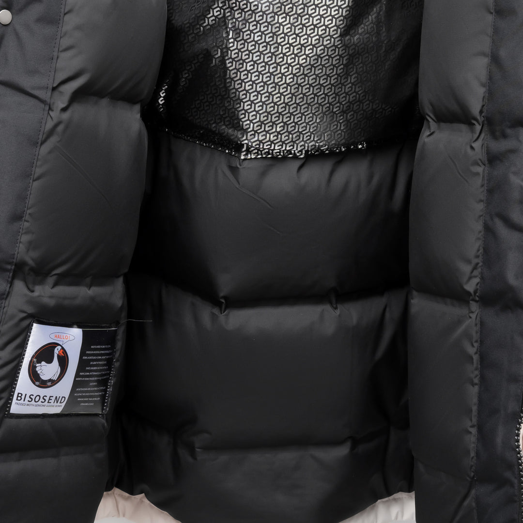 Woman wearing black hooded padded winter parka jacket outdoors