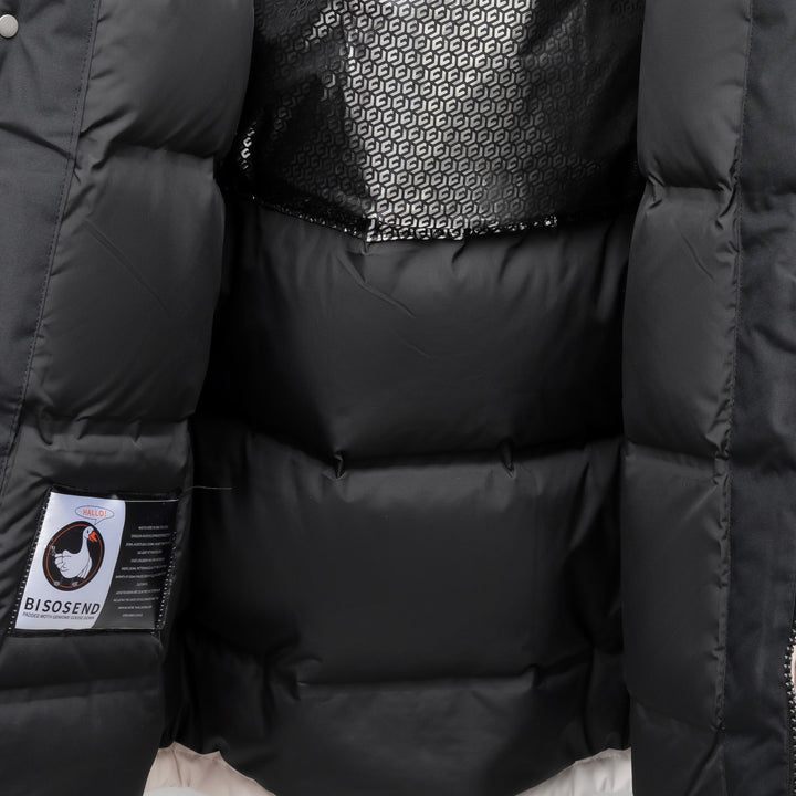 Woman wearing black hooded padded winter parka jacket outdoors