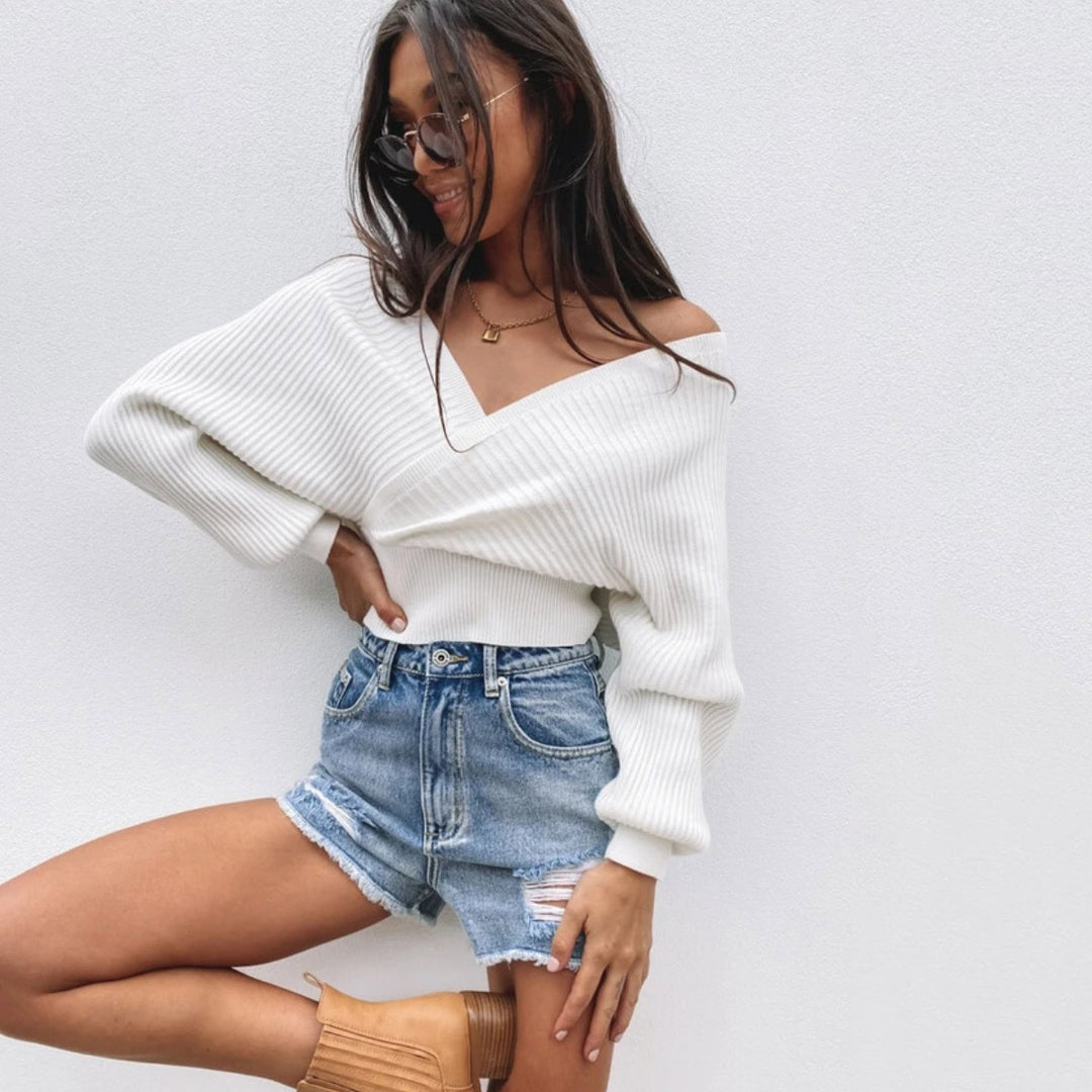Woman wearing loose lantern sleeve sweater in apricot