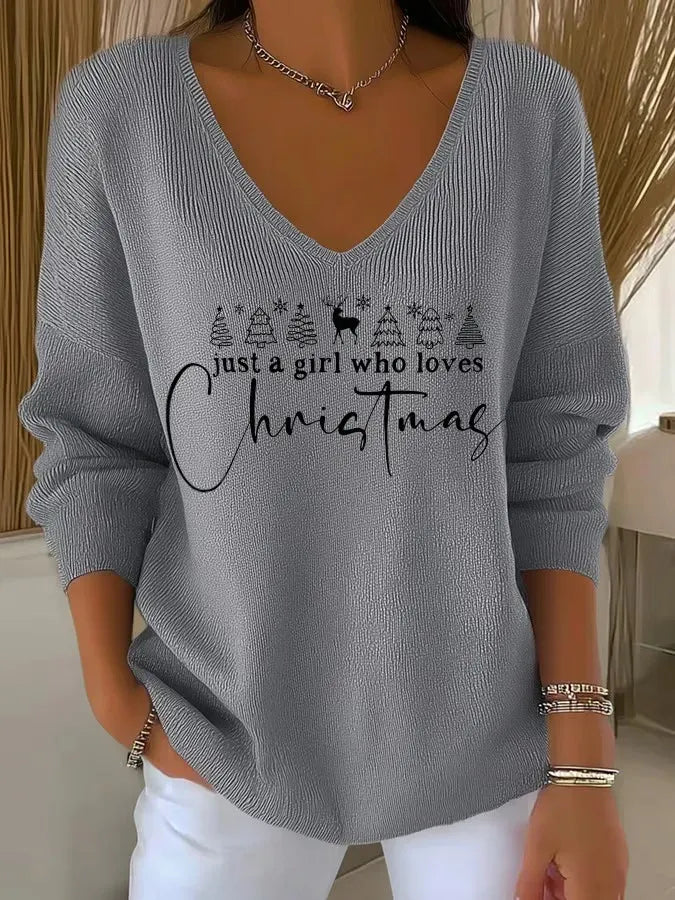 Woman wearing festive V-neck Christmas sweater with holiday print