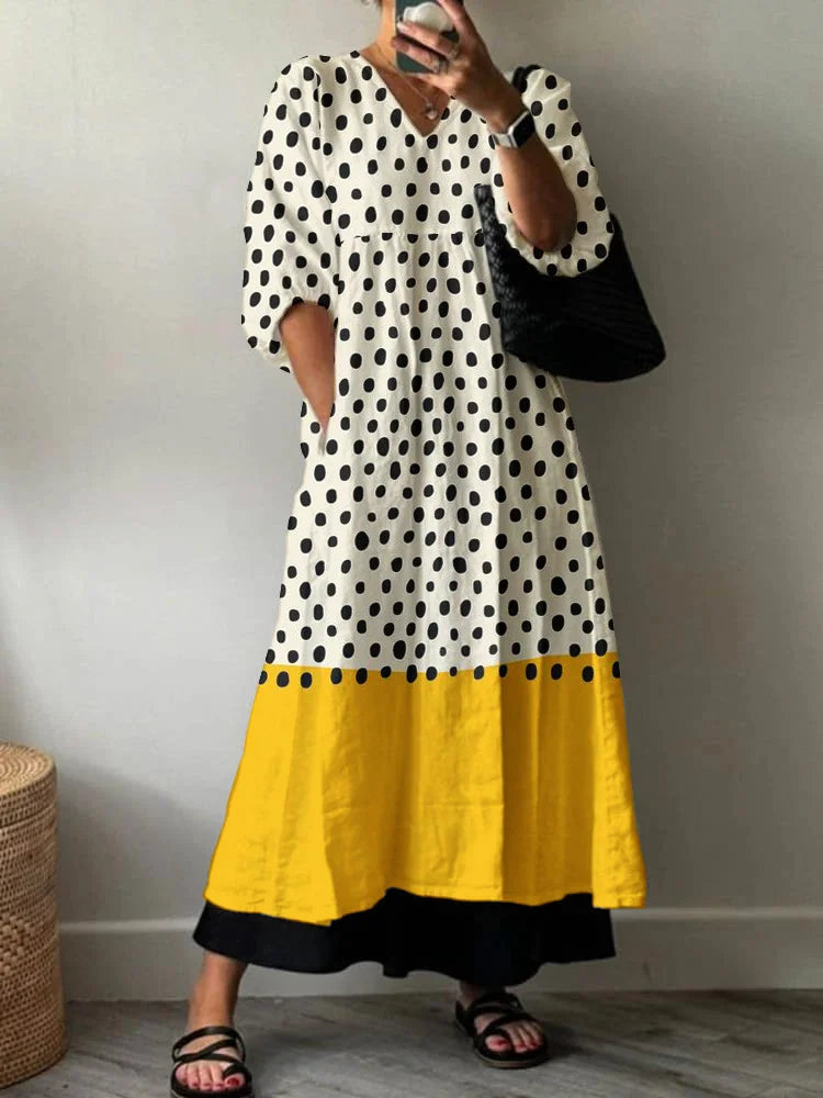 Woman wearing a flowy summer maxi dress with geometric print