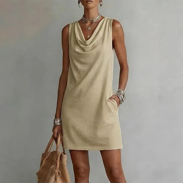 Woman wearing sleeveless mini dress with draped neckline
