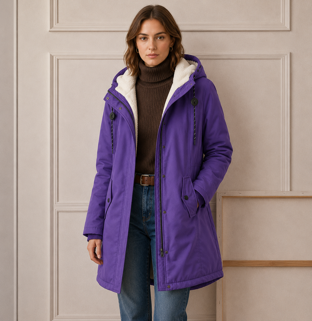 Woman wearing long quilted winter coat with hood outdoors