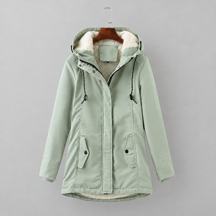 Woman wearing long quilted winter coat with hood outdoors