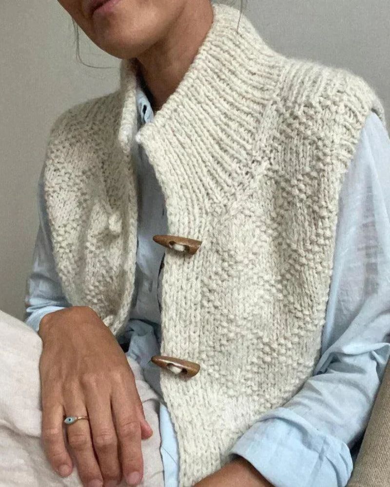 Woman wearing sleeveless knit vest layered over blouse