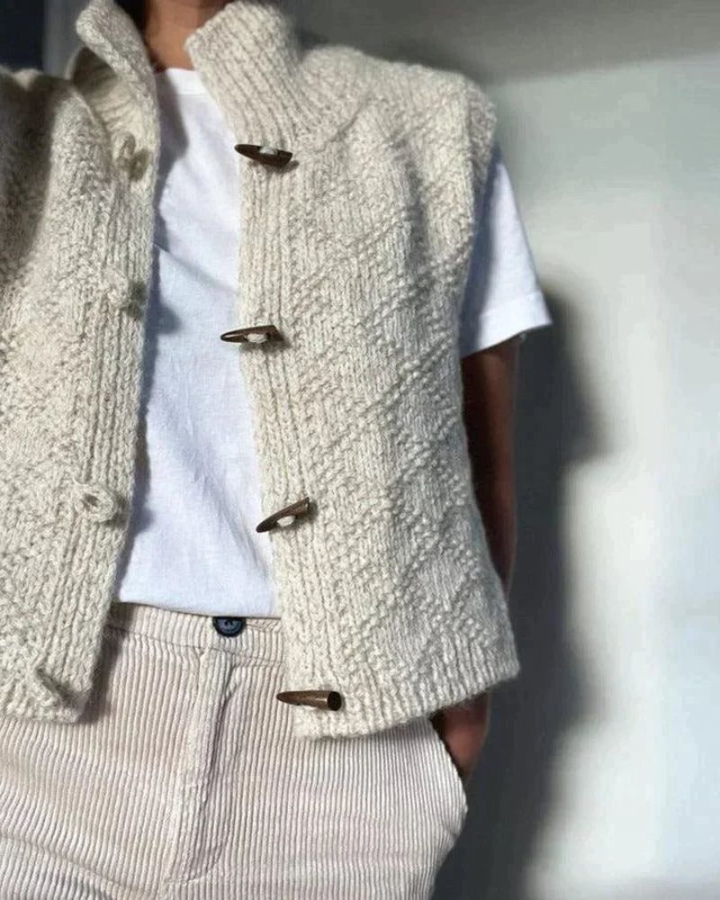 Woman wearing sleeveless knit vest layered over blouse