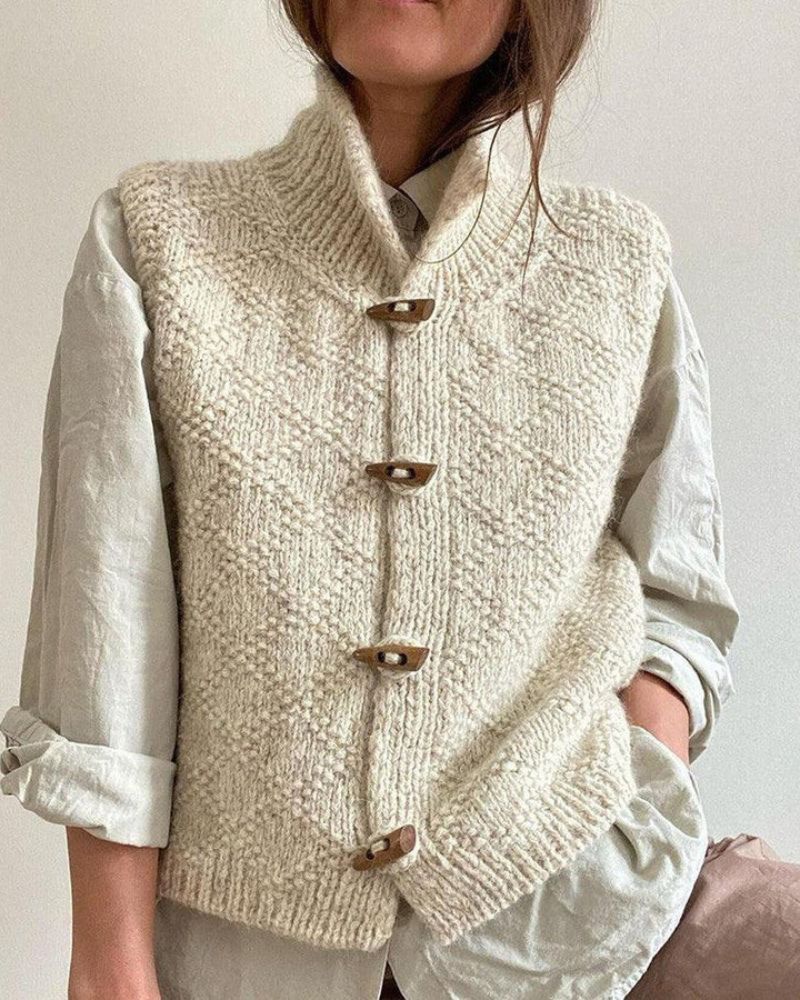 Woman wearing sleeveless knit vest layered over blouse