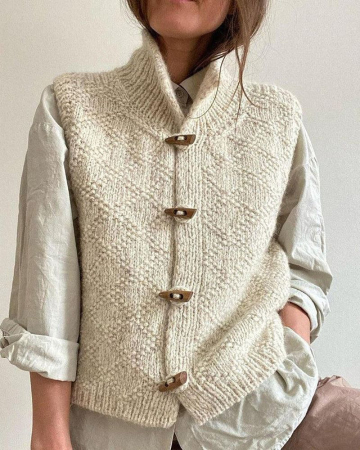 Woman wearing sleeveless knit vest layered over blouse