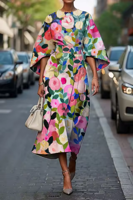 Woman wearing pink and green floral summer dress outdoors