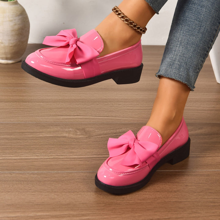 Women's pink bow loafers with classic moc-toe shape