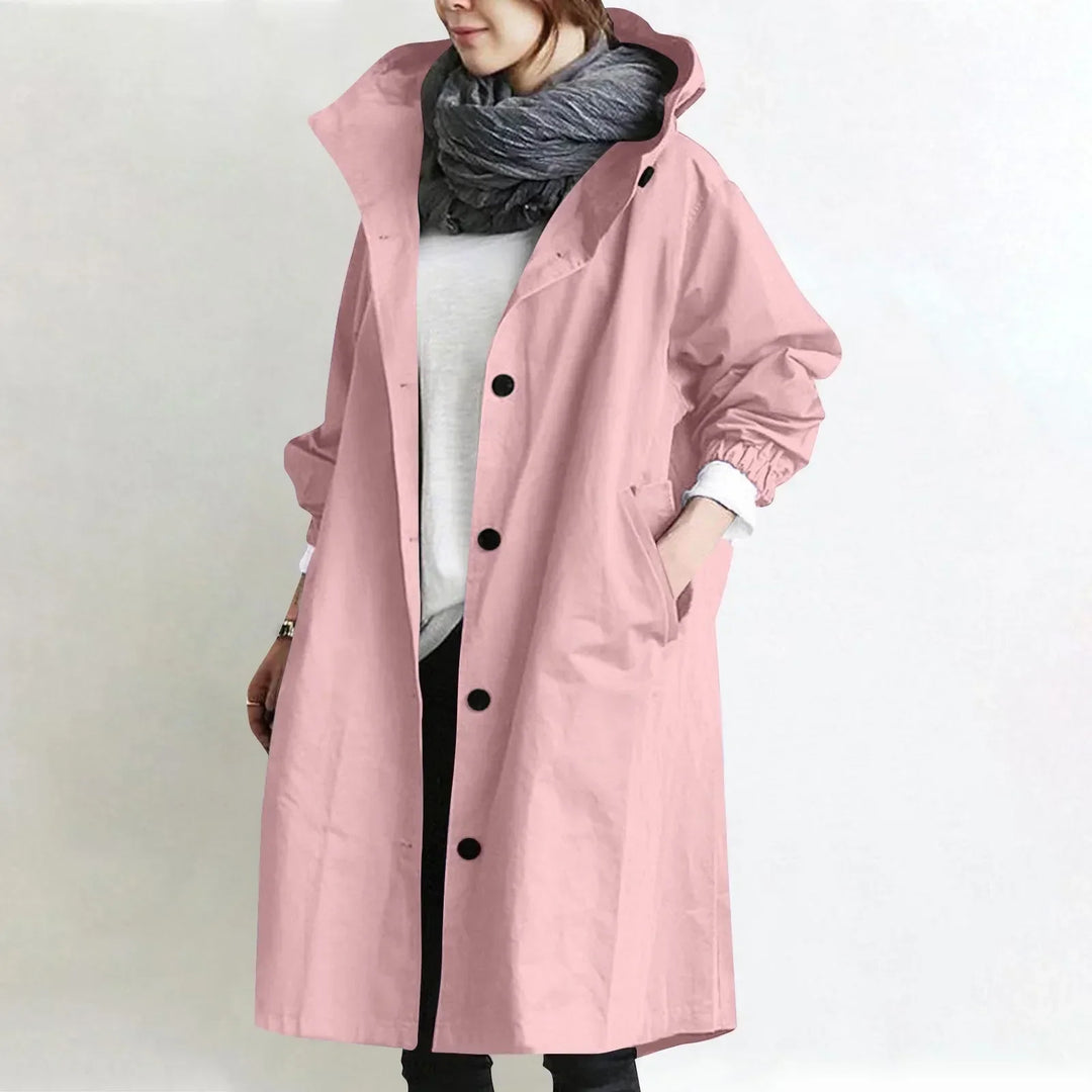 Woman wearing a hooded longline trench coat with button front