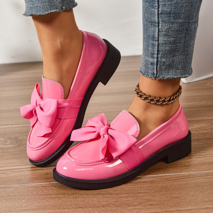 Women's pink bow loafers with classic moc-toe shape