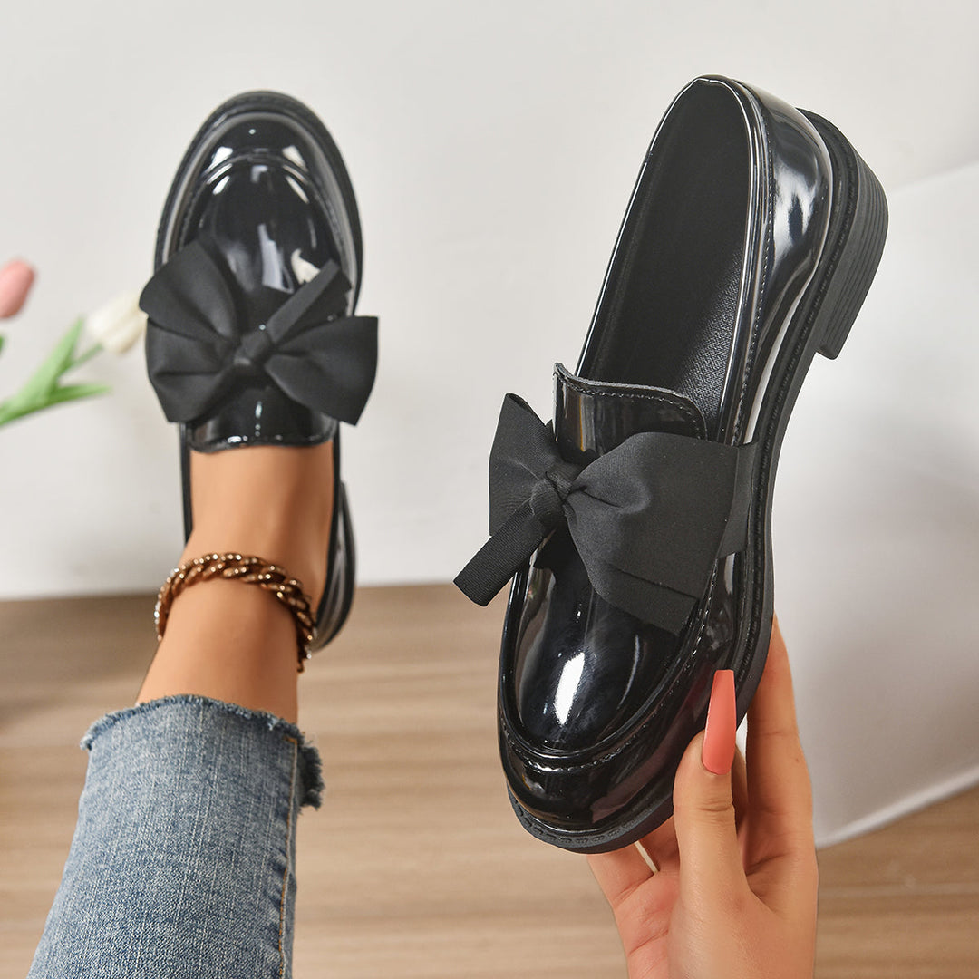 Women's pink bow loafers with classic moc-toe shape