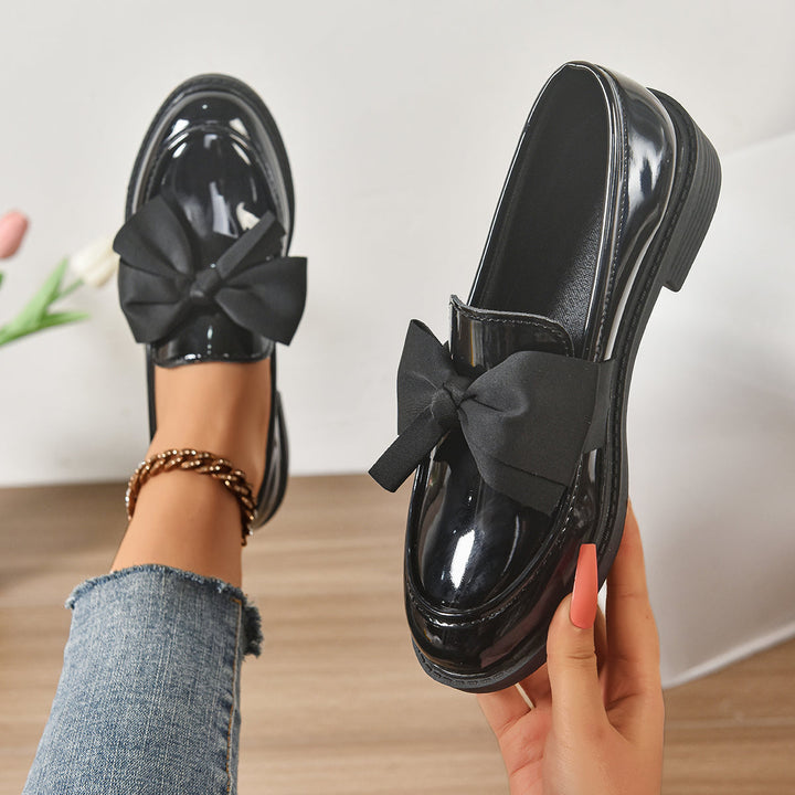 Women's pink bow loafers with classic moc-toe shape