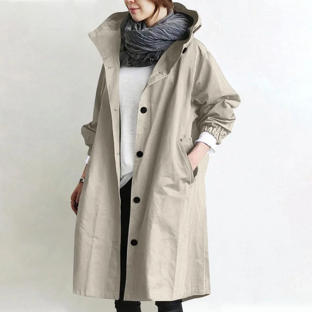 Woman wearing long hooded coat with button front