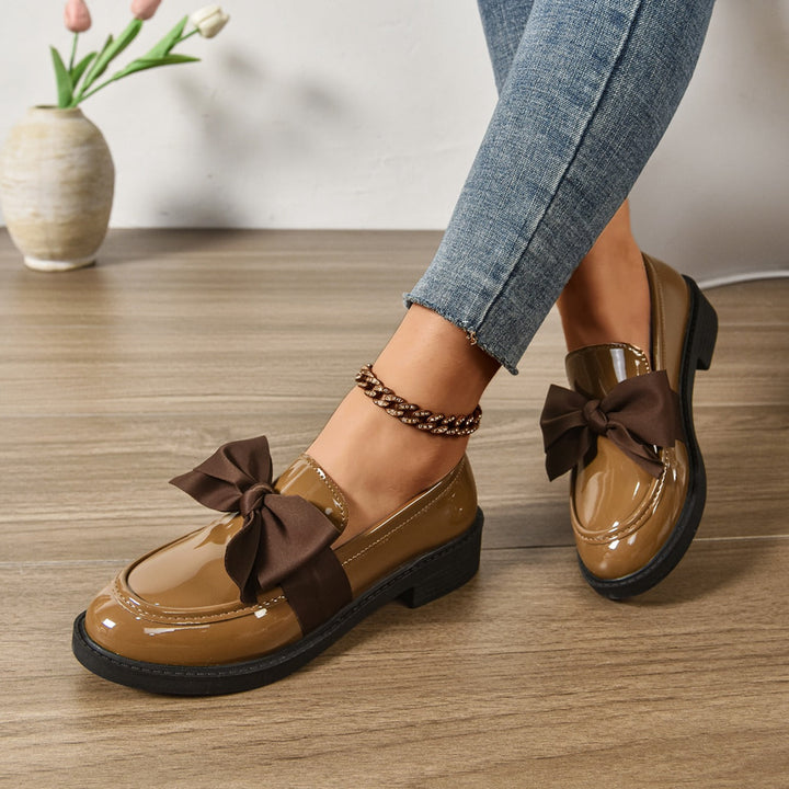 Women's pink bow loafers with classic moc-toe shape