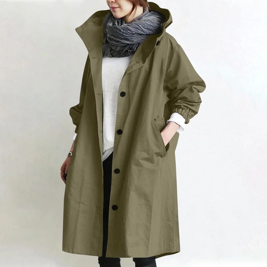 Woman wearing long hooded coat with button front