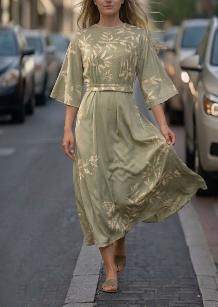 Woman wearing pink and green floral summer dress outdoors