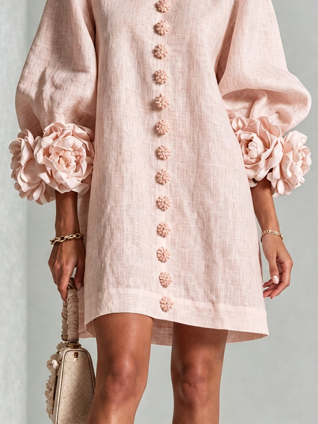 Woman wearing pink floral mini dress with rosette cuffs
