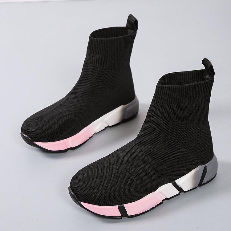 Woman wearing black and pink platform ankle boots