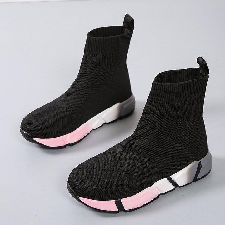 Woman wearing black and pink platform ankle boots