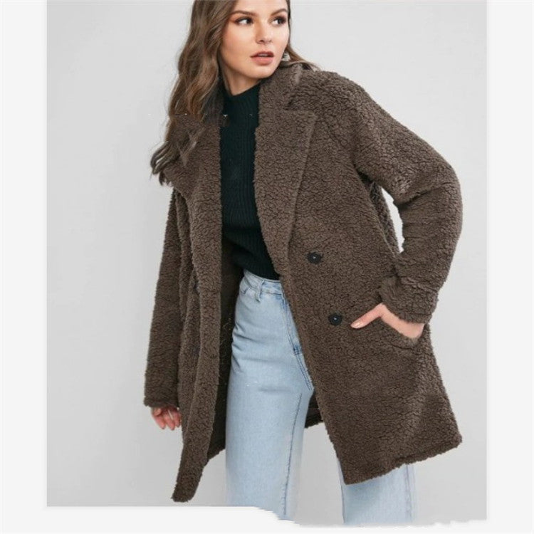 Woman wearing gray mid length loose coat with pockets